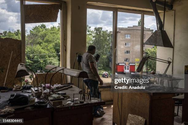 Neighbor collects and fixes the damage inside the building after the impact of the S-300 missile launched by the Russian troops and which affected...