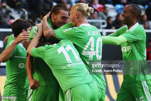 Bas Dost of Wolfsburg celebrates with his team mates after scoring his team's third goal during the Bundesliga match between Fortuna Duesseldorf 1895...