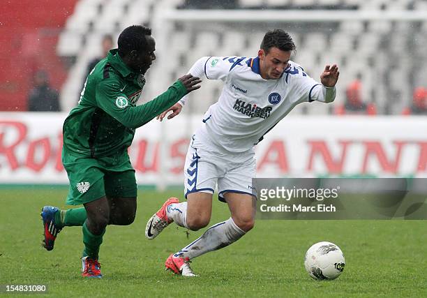 Addy-Waku Menga of Muenster challenges Danny Blum of Karlsruhe during the third league match between Karlsruher SC and Preussen Muenster at Wildpark...