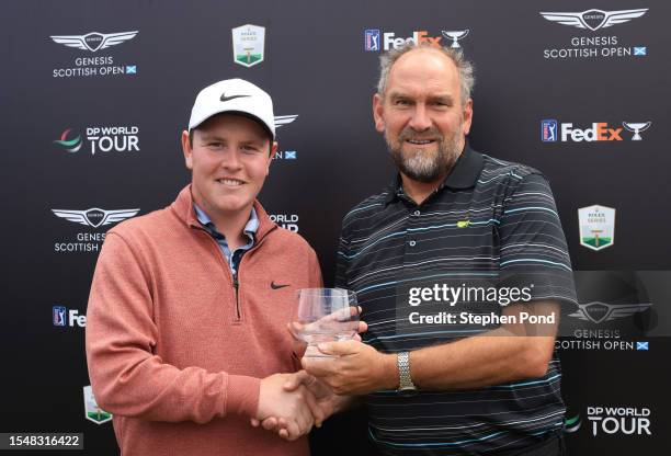 Robert MacIntyre of Scotland is presented with a trophy for the leading Scottish player in the tournament by Martin Dempster during Day Four of the...