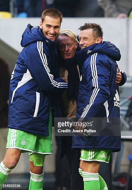 Bas Dost and Ivica Olic and interim head coach Lorenz-Guenther Koester of Wolfsburg celebrate after winning the Bundesliga match between Fortuna...