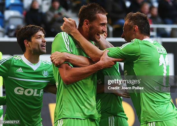 Bas Dost of Wolfsburg celebrates with his team mates after scoring his team's third goal during the Bundesliga match between Fortuna Duesseldorf 1895...
