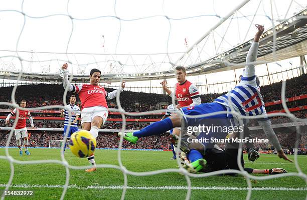 Mikel Arteta shoots the ball past QPR defender Ryan Nelson to score the only goal of the game during the Barclays Premier League match between...