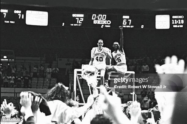 American basketball players Jeff King and Phil Gamble, of the University of Connecticut, celebrate their team's National Invitation Tournament...