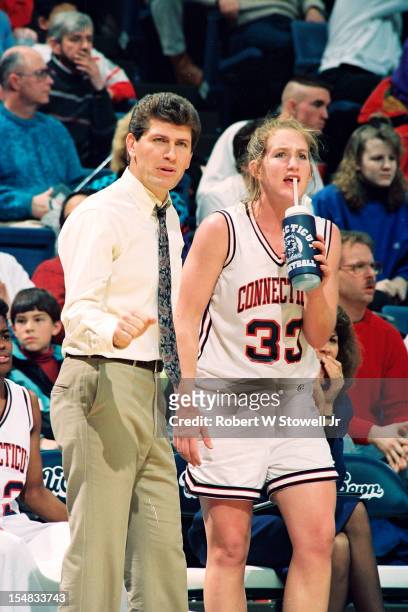 Italian-born American women's basketball coach Geno Auriemma, of the University of Connecticut, stands courtside with one of his players, Meghan...