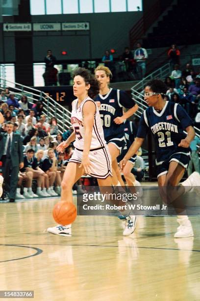 American basketball player Debbie Baer, of the University of Connecticut, looks up court as she dribbles during a game against the Georgetown Hoyas,...