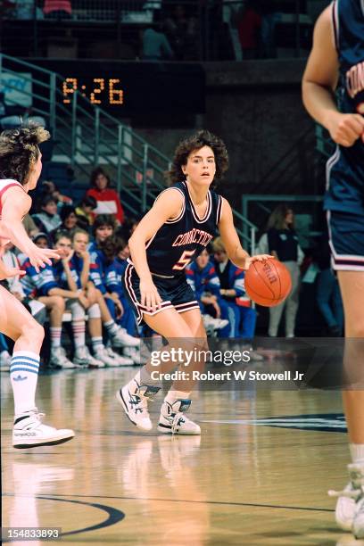 American basketball player Debbie Baer, of the University of Connecticut, looks up court as she dribbles against the defense during a game, Storrs,...