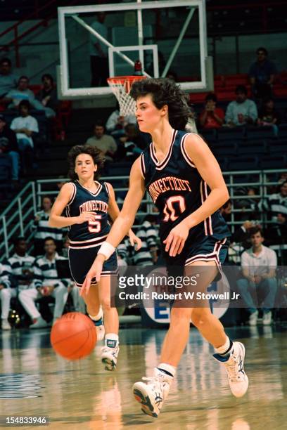 American basketball player Laura Lishness, of the University of Connecticut, dribbles the ball as teammate Debbie Baer runs up court, Storrs,...