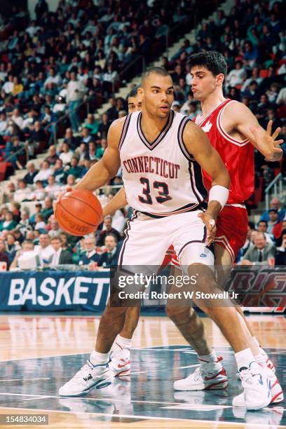 American basketball player Donny Marshall, of the University of Connecticut, drives against a member of the Canadian national team, Hartford...