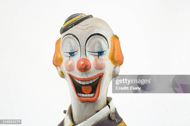 laughing vintage tin toy clown with finely painted features. - clown stock pictures, royalty-free photos & images