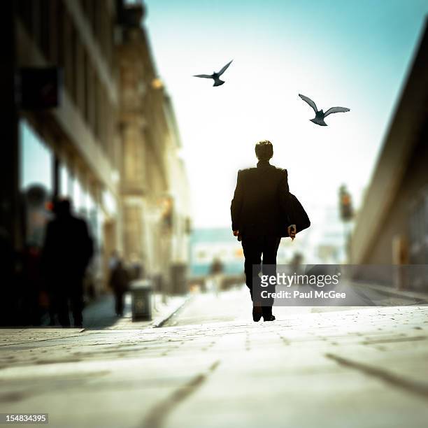 businessman walking in the street - paul frees stock-fotos und bilder