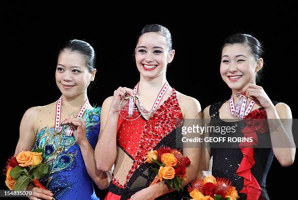 Gold medalist Kaetlyn Osmond of Canada is joined by silver medalist Akiko Suzuki of Japan and bronze medalist Kanako Murakami of Japan during the...