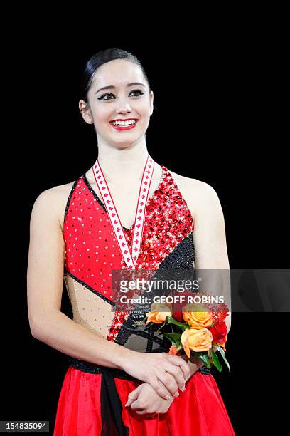Gold medalist Kaetlyn Osmond of Canada listens to the national anthem during the medal ceremony for the ladies competition at the 2012 Skate Canada...