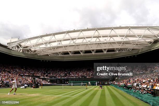 Carlos Alcaraz of Spain serves during the Men's Singles Final against Novak Djokovic of Serbia on day fourteen of The Championships Wimbledon 2023 at...