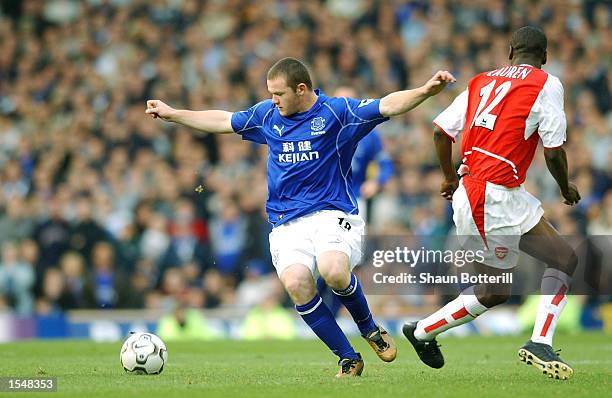 Wayne Rooney of Everton takes on Lauren of Arsenal during the FA Barclaycard Premiership match between Everton and Arsenal at Goodison Park in...