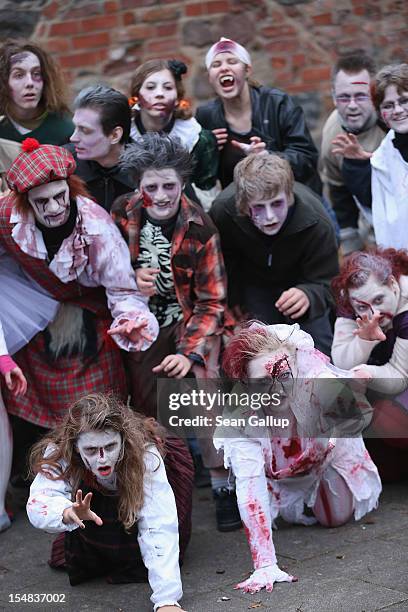 Zombie enthusiasts rehearse a dance before setting out on a "Zombie Walk" in the city center on October 27, 2012 in Berlin, Germany. Approximately...