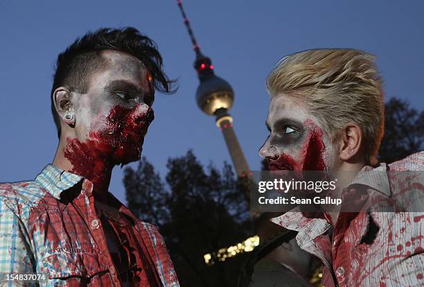 Zombie enthiusiasts gather near the broadcast tower at Alexanderplatz before setting out on a "Zombie Walk" in the city center on October 27, 2012 in...