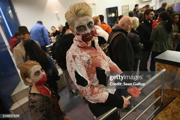 Zombie enthiusiasts stop for a bite to eat at a popular fast food chain during a "Zombie Walk" in the city center on October 27, 2012 in Berlin,...