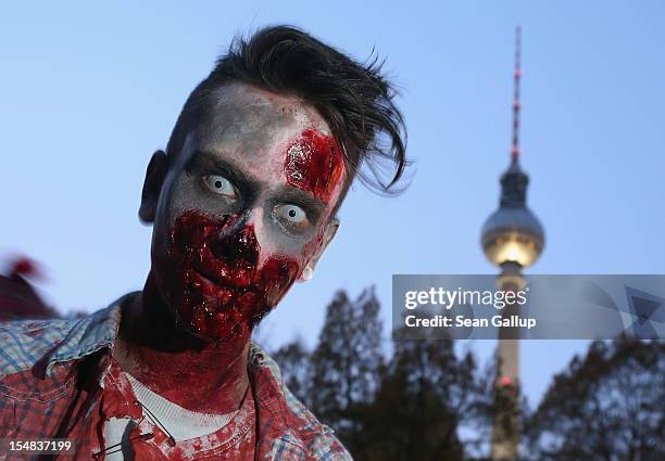 Zombie enthiusiasts gather near the broadcast tower at Alexanderplatz before setting out on a "Zombie Walk" in the city center on October 27, 2012 in...