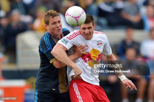 Chris Albright of the Philadelphia Union and Kenny Cooper of the New York Red Bulls try to head the ball at PPL Park on October 27, 2012 in Chester,...