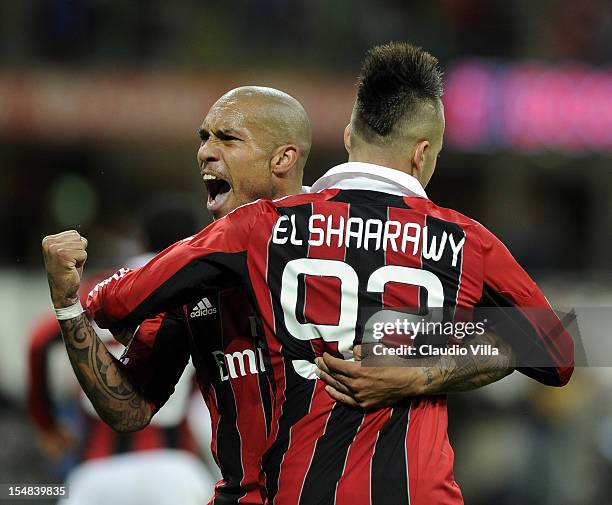 Stephan El Shaarawy and Nigel De Jong of AC Milan celebrate scoring the first goal during the Serie A match between AC Milan and Genoa CFC at San...