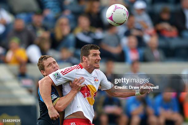 Chris Albright of the Philadelphia Union and Kenny Cooper of the New York Red Bulls try to head the ball at PPL Park on October 27, 2012 in Chester,...