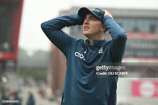 England's Harry Brook looks up at the sky as rain delays the start of play on day five of the fourth Ashes cricket Test match between England and...