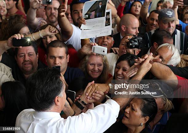 Republican presidential candidate, former Massachusetts Gov. Mitt Romney greets supporters during a campaign rally at Ranger Jet Center on October...