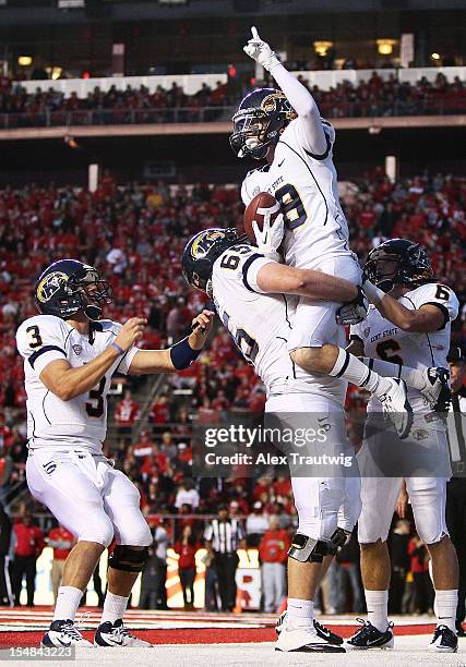 Josh Boyle of the Kent State Golden Flashes celebrates a touchdown with teammates Spencer Keith, Kent Cleveland, and Chris Humphrey at High Point...