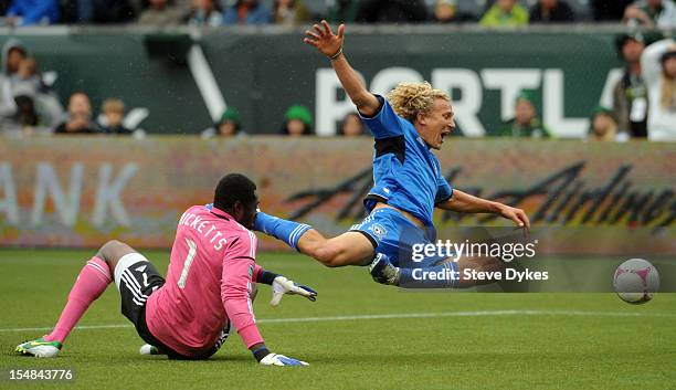 Donovan Ricketts of Portland Timbers and Steven Lenhart of San Jose Earthquakes go after a ball during the first half of the game at Jeld-Wen Field...