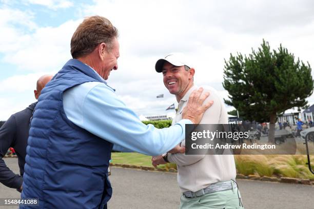 Rory McIlroy of Northern Ireland celebrates with putting coach, Brad Faxon, after winning the tournament during Day Four of the Genesis Scottish Open...