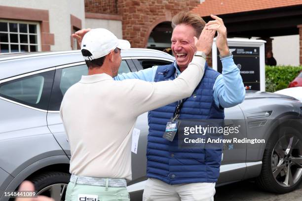Rory McIlroy of Northern Ireland celebrates with putting coach, Brad Faxon, after winning the tournament during Day Four of the Genesis Scottish Open...