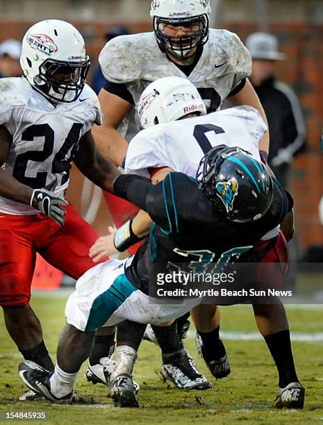Coastal Carolina linebacker Quinn Backus sacks Liberty quarterback Josh Woodrum at Brooks Stadium in Conway, South Carolina, on Saturday, October 27,...