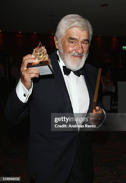 Mario Adorf holds up his award during the 21st UNESCO Charity Gala 2012 on October 27, 2012 in Dusseldorf, Germany.