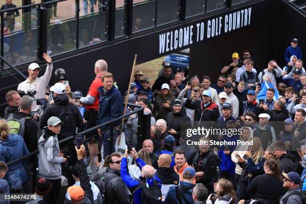 Rory McIlroy of Northern Ireland acknowledges the crowd as he walks to the 18th green for the prize giving ceremony during Day Four of the Genesis...