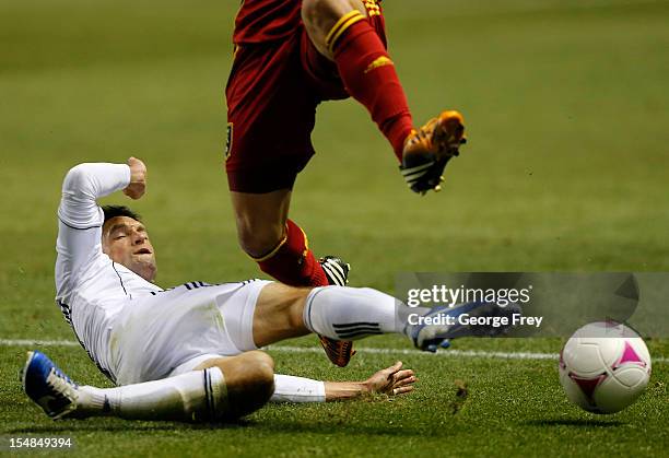 John Thorrington of Vancouver Whitecaps takes the ball away from Tony Beltran of Real Salt Lake during the second half of an MLS soccer game October...