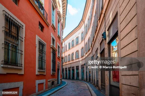 narrow street in the old town of milan, italy - small apartment building exterior stock pictures, royalty-free photos & images