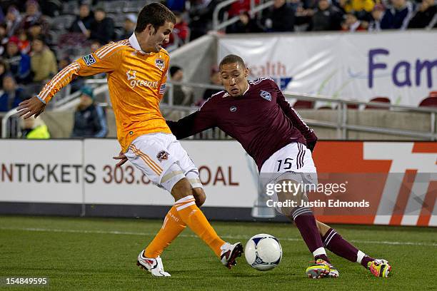 Chris Klute of the Colorado Rapids cuts the ball back against Nathan Sturgis of the Houston Dynamo at Dick's Sporting Goods Park on October 27, 2012...