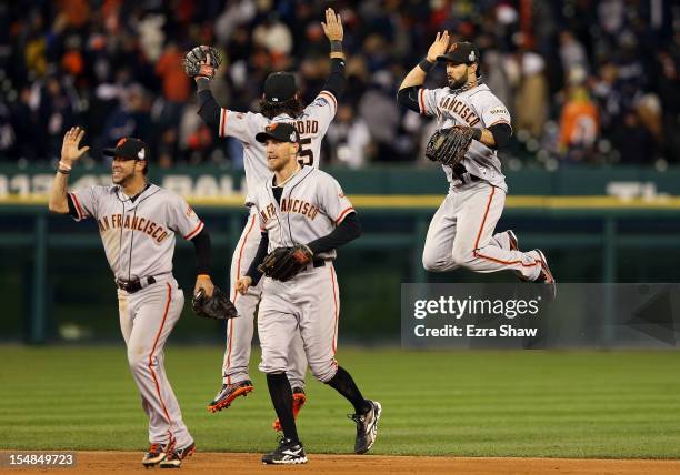 Gregor Blanco of the San Francisco Giants celebrates with teammates Hunter Pence, Brandon Crawford and Angel Pagan after defeating the Detroit Tigers...