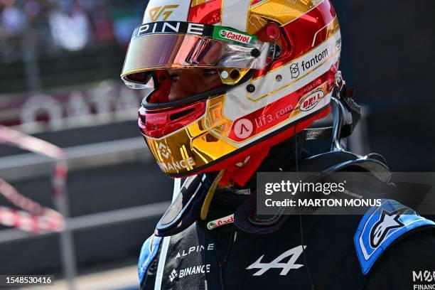 Alpines's French driver Pierre Gasly walks in the pits after being involved in a collision with his teammate Ocon, and both Alpines are out, during...