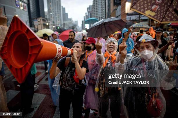 Pro-democracy protesters gesture during a demonstration in support of the Move Forward Party in Bangkok on July 23, 2023 after Thailand's parliament...