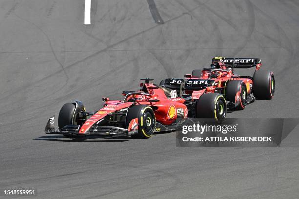 Ferrari's Monegasque driver Charles Leclerc and Ferrari's Spanish driver Carlos Sainz Jr. Race during the Formula One Hungarian Grand Prix at the...