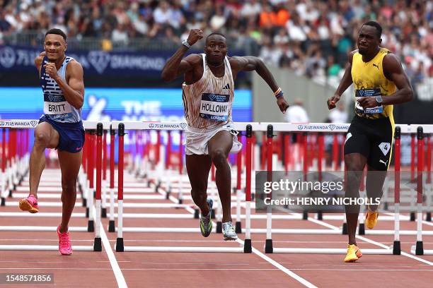 S Jamal Britt, USA's Grant Holloway and Jamaica's Hansle Parchment compete in the men's 110m hurdles event during the IAAF Diamond League athletics...