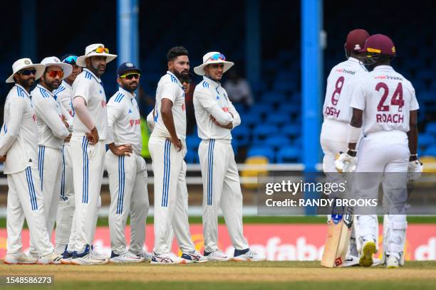 Ravindra Jadeja , Rohit Sharma , Ravichandran Ashwin , Ajinkya Rahane , Mohammed Siraj and Shubman Gill , of India, look at Alzarri Joseph , of West...