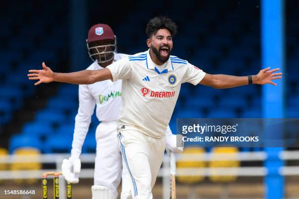 Mohammed Siraj , of India, celebrates the dismissal of Alzarri Joseph , of West Indies, during the fourth day of the second Test cricket match...