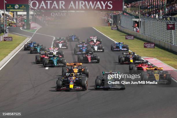 Max Verstappen of the Netherlands driving the Oracle Red Bull Racing RB19 leads Lewis Hamilton of Great Britain driving the Mercedes AMG Petronas F1...