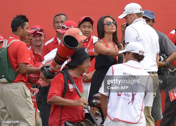 Nick Watney of the US is greeted by his wife Amber Watney after winning the 6.1 million USD CIMB Classic golf tournament at The Mines Resort and Golf...