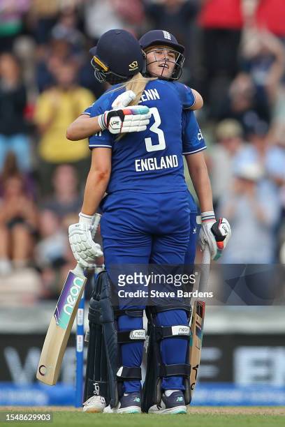 Natalie Sciver-Brunt of England celebrates reaching her century with Sarah Glenn during the Women's Ashes 2nd We Got Game ODI match between England...
