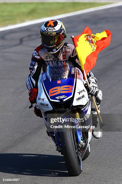 Jorge Lorenzo of Spain and Yamaha Factory Team celebrates with the Spanish flag after achieving second place and overall victory in the MotoGp...