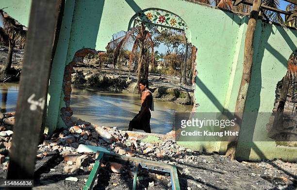 Man walks past a detroyed mosque at quarter No.3 in Pauktaw township, that was burned in recent violence between Buddhist Rakhine and Muslim...